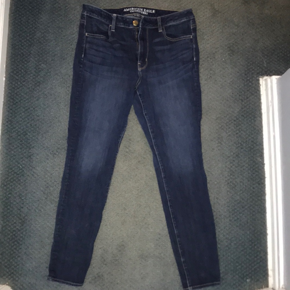 Dark wash blue jeans. No rips.